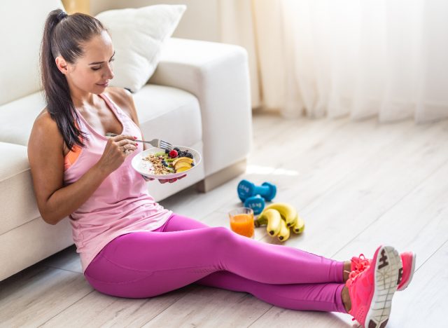 fitness woman eating bowl of yogurt