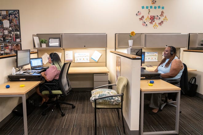 Professional mental health supervisors Karen Duran and Yashi Duhon answer calls from the crisis hotline. "We can help them see the light," Duran said. "We are always here for someone."