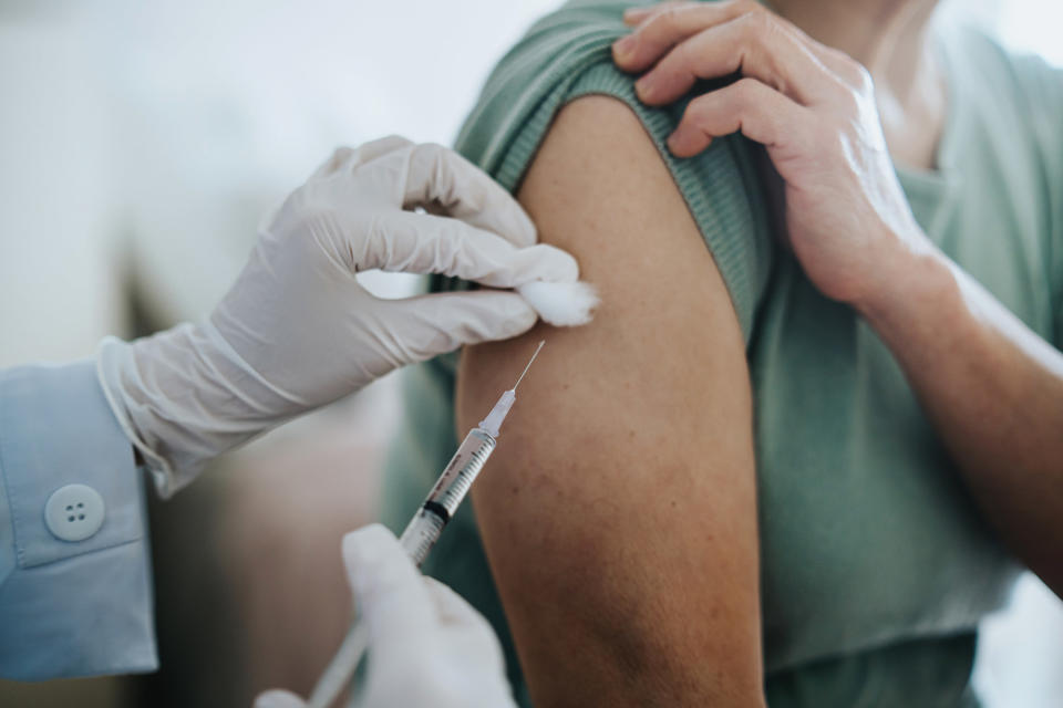 A doctor administering a vaccine into a person's arm