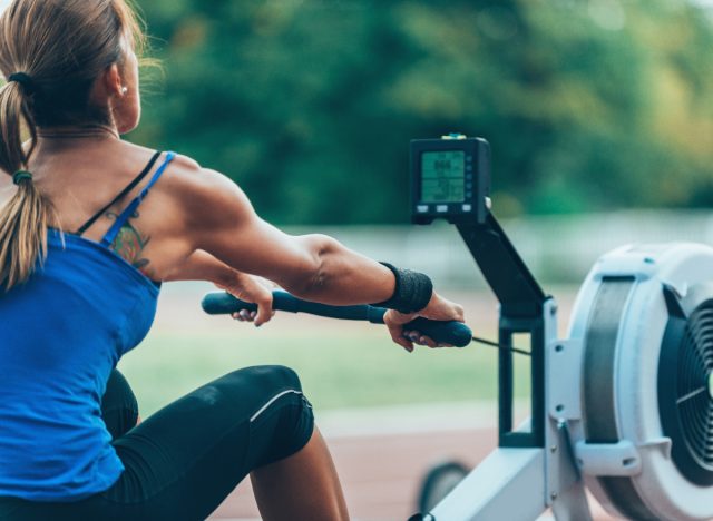 muscular woman workout rowing machine