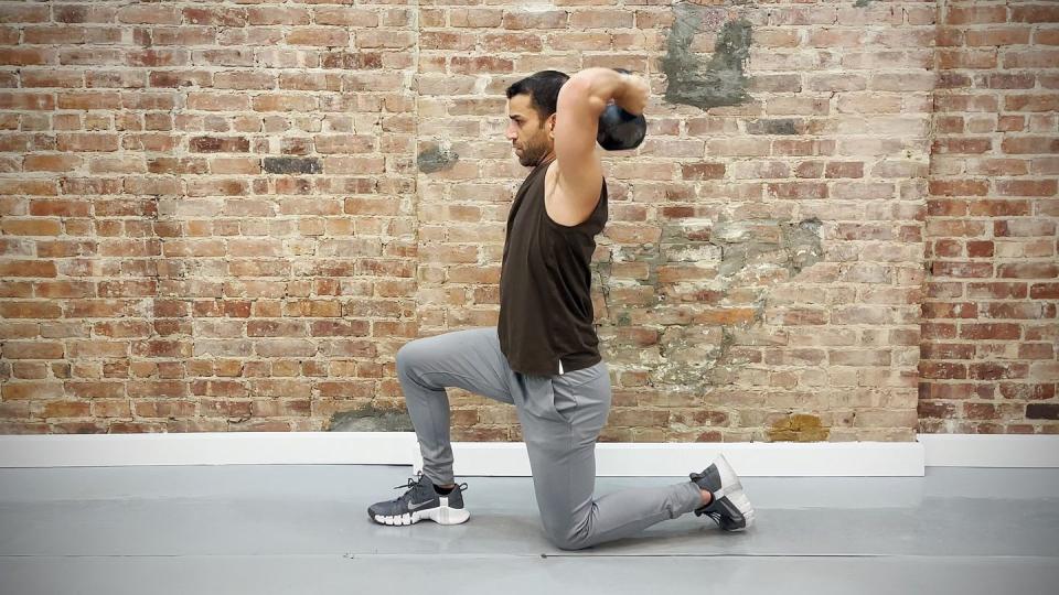 tamir practicing the halo exercise while kneeling