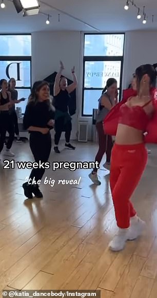 Katia took off a red puffer jacket to reveal her pregnant belly in the montage video clip