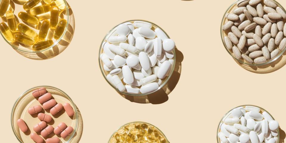 various pills and capsules, vitamins and dietary supplements in petri dishes on a beige background