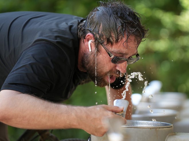 Brian Reynolds cools off while pedaling the Ann and Roy Butler Hike and Bike Trail. For people taking certain medications, the risk of dehydration can become an even greater problem.
