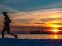 A jogger trains on the boardwalk in Dorval in 2020. Unlike advice on how long or how hard you should train, there are no official guidelines on the best time of day to train.