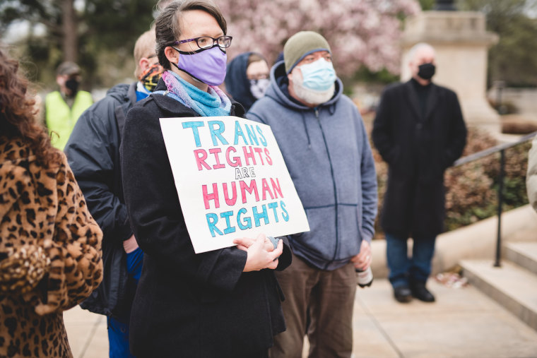Protesters protest outside the state capitol in Little Rock, Arkansas March 18, 2021, as lawmakers consider a bill that bans state doctors from providing transition-related health care to transgender minors.