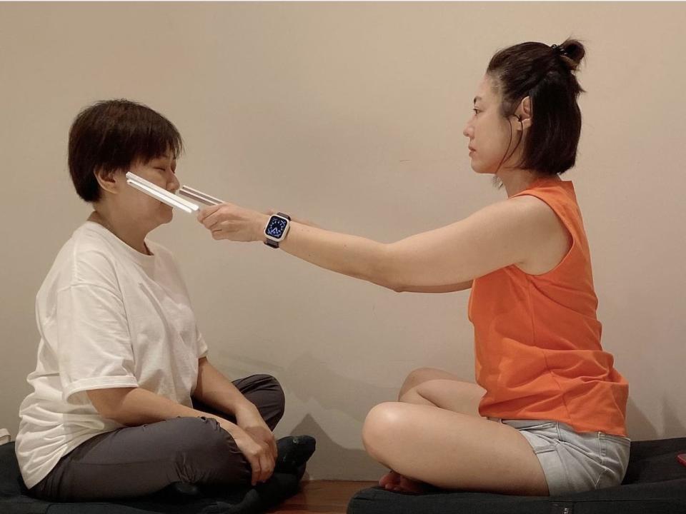Cynthia Koh performs tuning fork sound therapy on client (Photo: pure__potential/Instagram)