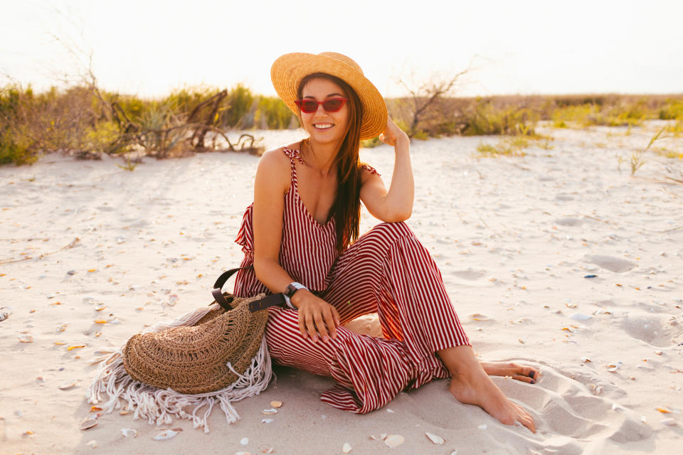 Woman-wearing-romper-at-the-beach-stock-photo