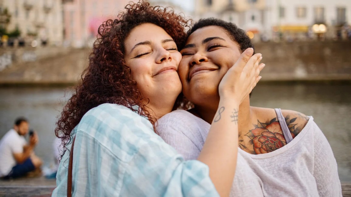 Two friends hugging each other.