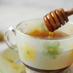 raw honey poured into cup of tea