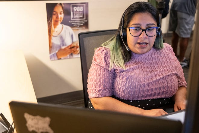 Professional mental health supervisor Karen Duran takes calls Wednesday from the 988 crisis hotline in the Integral Cares Dove Springs Clinic call center. A year ago, the National Suicide & Prevention Hotline introduced the 988 emergency phone number.