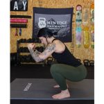 Woman demonstrates proper squat form