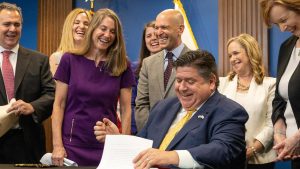 Oh, I signed! says State Senator Laura Fine, D-Glenview, as she realizes that her bill giving the Department of Insurance new oversight authority was approved by Gov. JB Pritzker on June 27, 2023. (Andrew Adams/Capitol Illinois News)